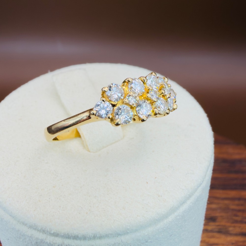 An 18ct yellow gold Art Deco cluster ring set with ten old European cut diamonds arranged in a contoured multi-row setting. View XV