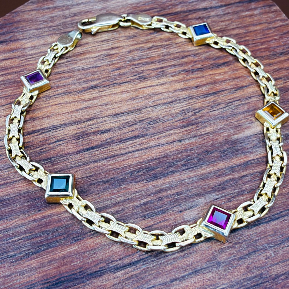 A 14ct yellow gold textured link bracelet featuring five square princess-cut multi-coloured gemstones. View V