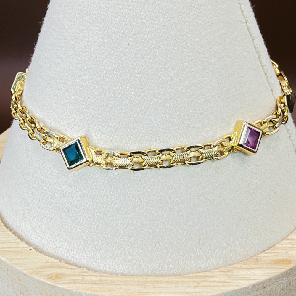 A 14ct yellow gold textured link bracelet featuring five square princess-cut multi-coloured gemstones. View VI