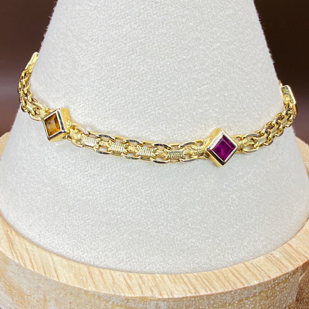 A 14ct yellow gold textured link bracelet featuring five square princess-cut multi-coloured gemstones. View VII