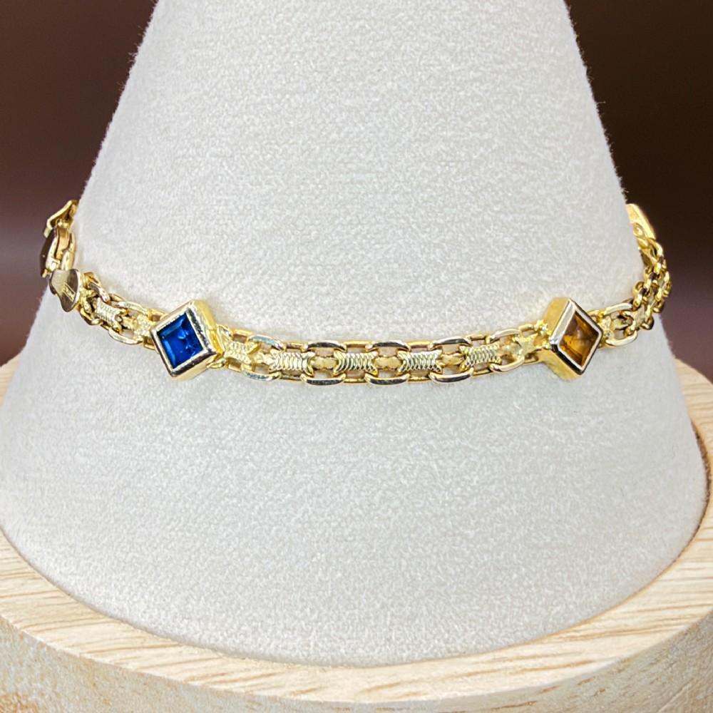 A 14ct yellow gold textured link bracelet featuring five square princess-cut multi-coloured gemstones. View VIII