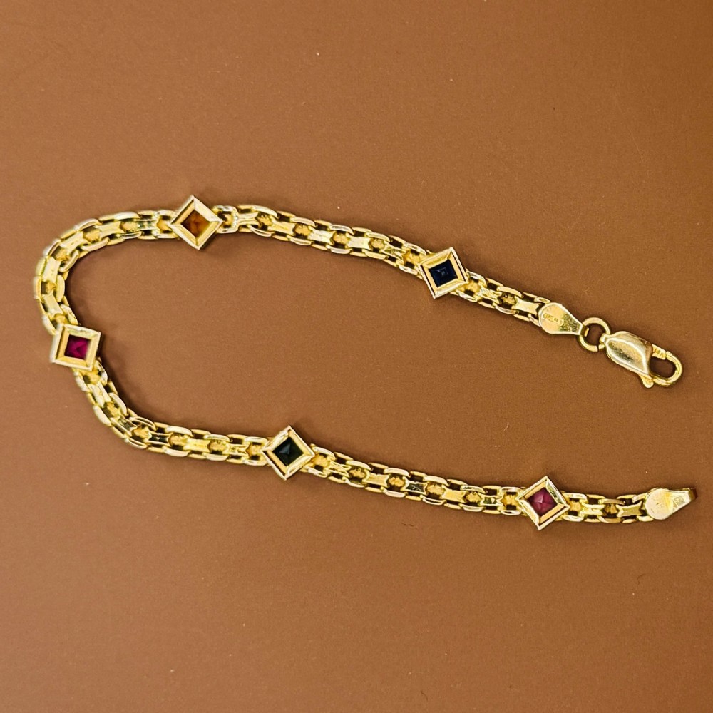 A 14ct yellow gold textured link bracelet featuring five square princess-cut multi-coloured gemstones. View XI