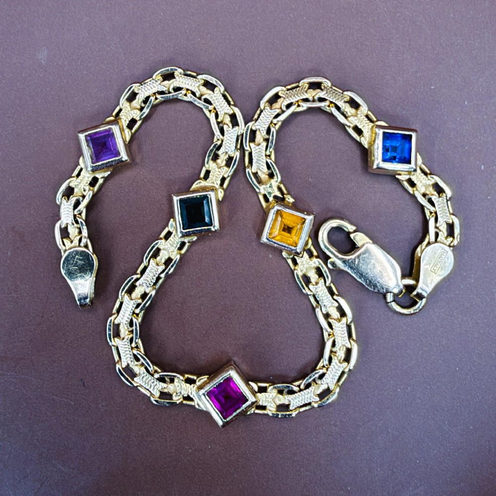 A 14ct yellow gold textured link bracelet featuring five square princess-cut multi-coloured gemstones. View XII