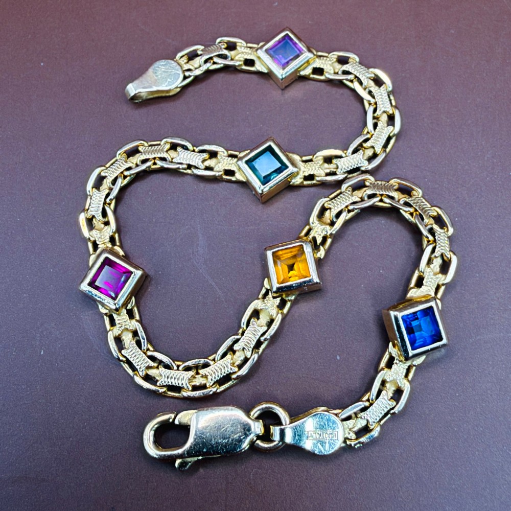 A 14ct yellow gold textured link bracelet featuring five square princess-cut multi-coloured gemstones. View XIII