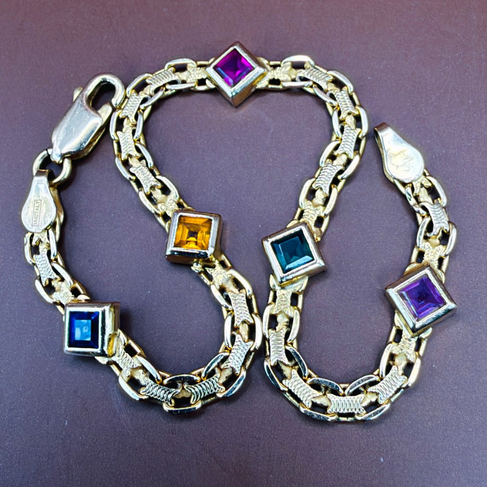 A 14ct yellow gold textured link bracelet featuring five square princess-cut multi-coloured gemstones. View XIV