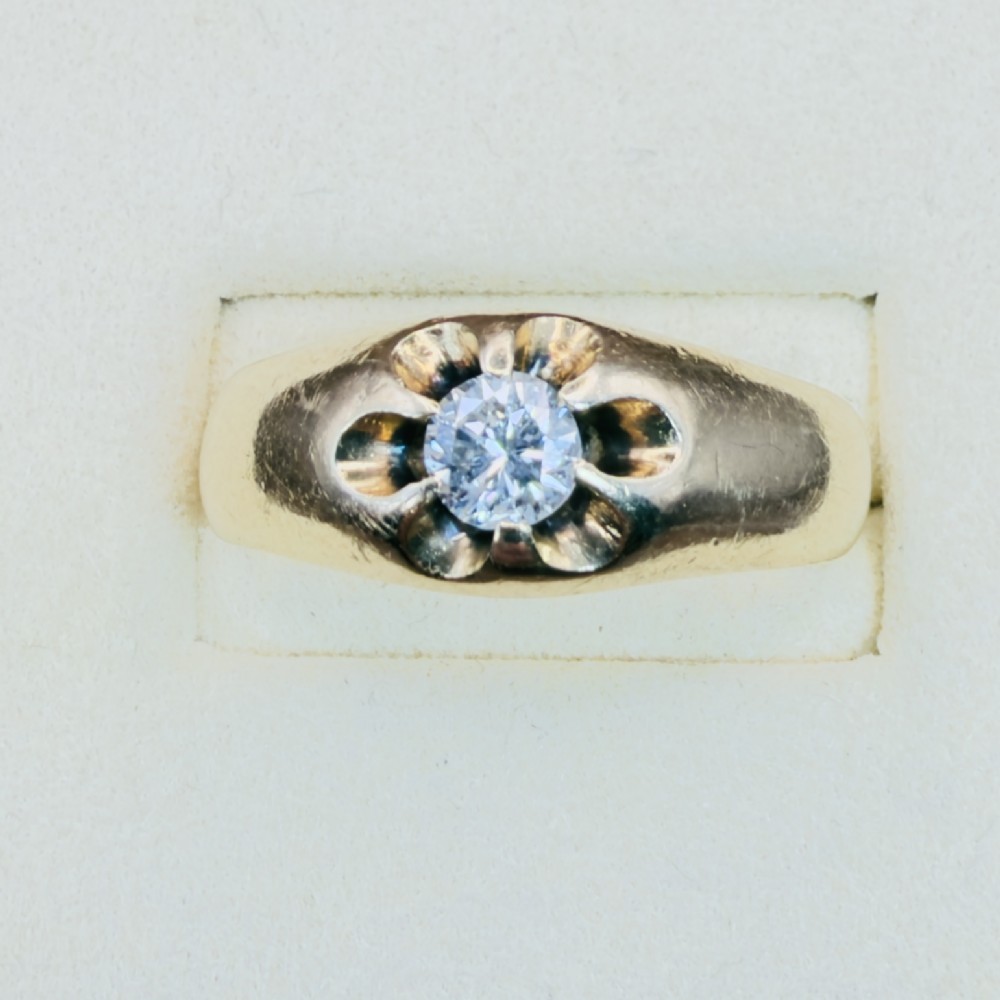 An 18ct yellow gold mens solitaire ring featuring a single diamond mounted in a carved starburst setting. View III