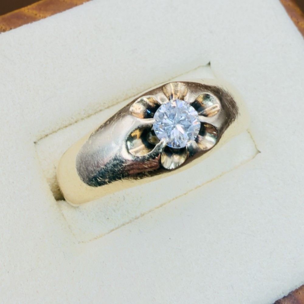An 18ct yellow gold mens solitaire ring featuring a single diamond mounted in a carved starburst setting. View II