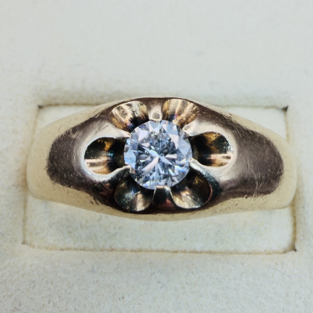 An 18ct yellow gold mens solitaire ring featuring a single diamond mounted in a carved starburst setting. View V