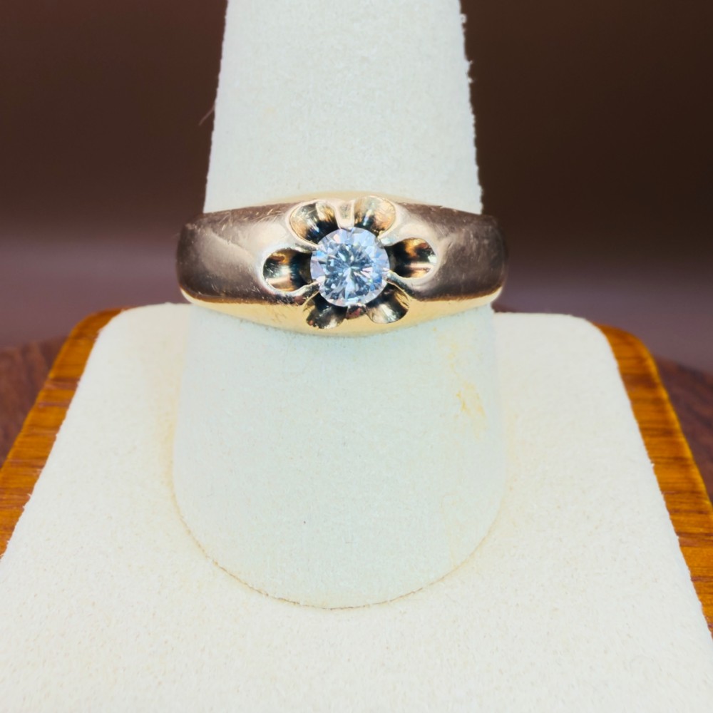 An 18ct yellow gold mens solitaire ring featuring a single diamond mounted in a carved starburst setting. View VI