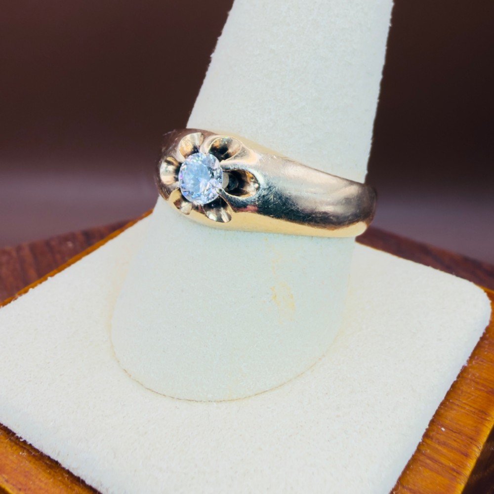 An 18ct yellow gold mens solitaire ring featuring a single diamond mounted in a carved starburst setting. View VII