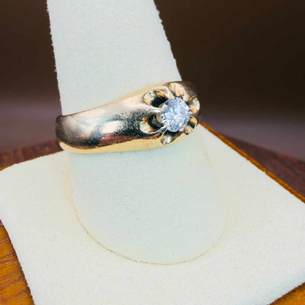 An 18ct yellow gold mens solitaire ring featuring a single diamond mounted in a carved starburst setting. View VIII