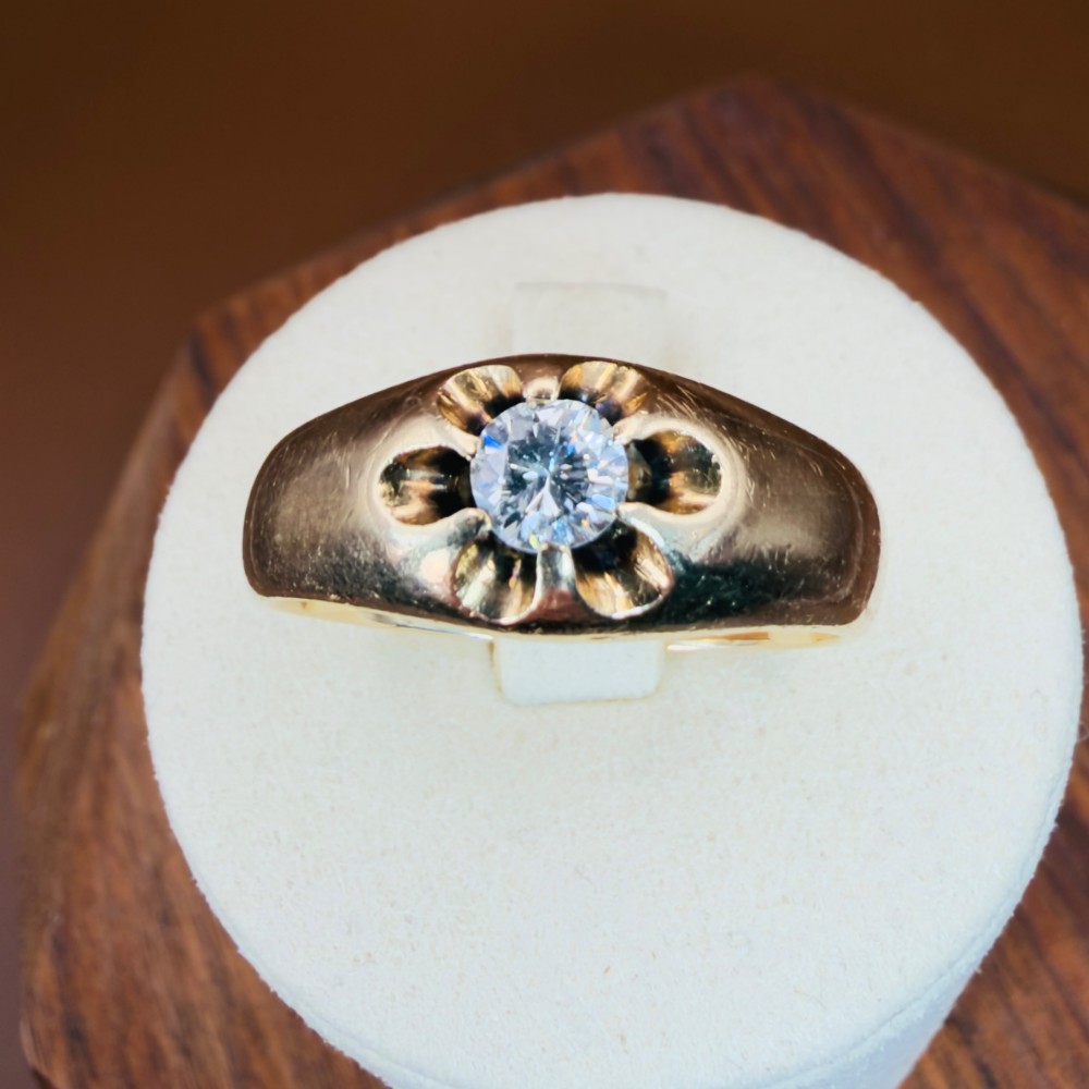 An 18ct yellow gold mens solitaire ring featuring a single diamond mounted in a carved starburst setting. View XII