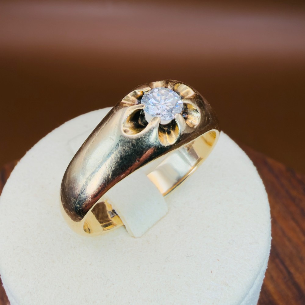 An 18ct yellow gold mens solitaire ring featuring a single diamond mounted in a carved starburst setting. View XIII