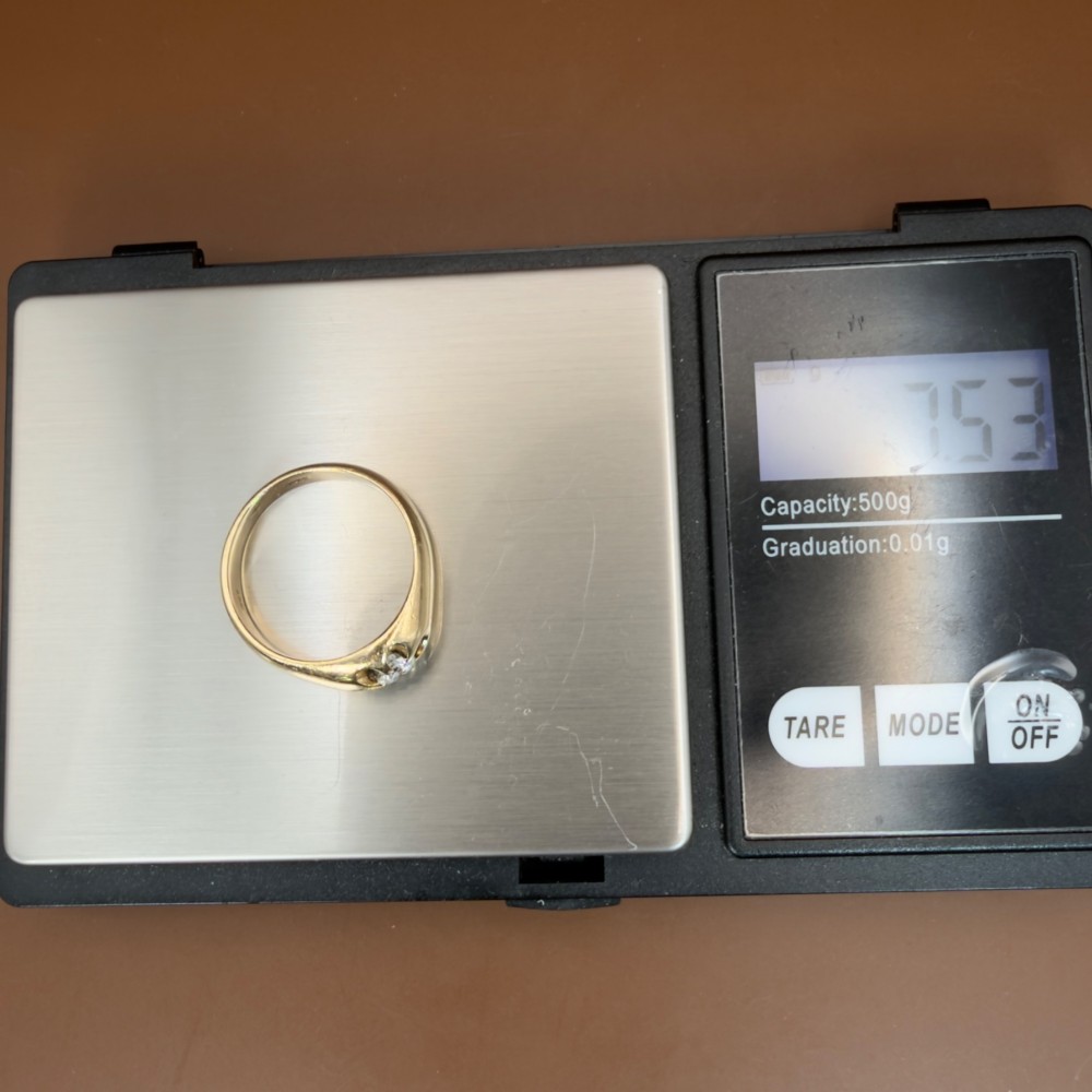 An 18ct yellow gold mens solitaire ring featuring a single diamond mounted in a carved starburst setting. View XIV