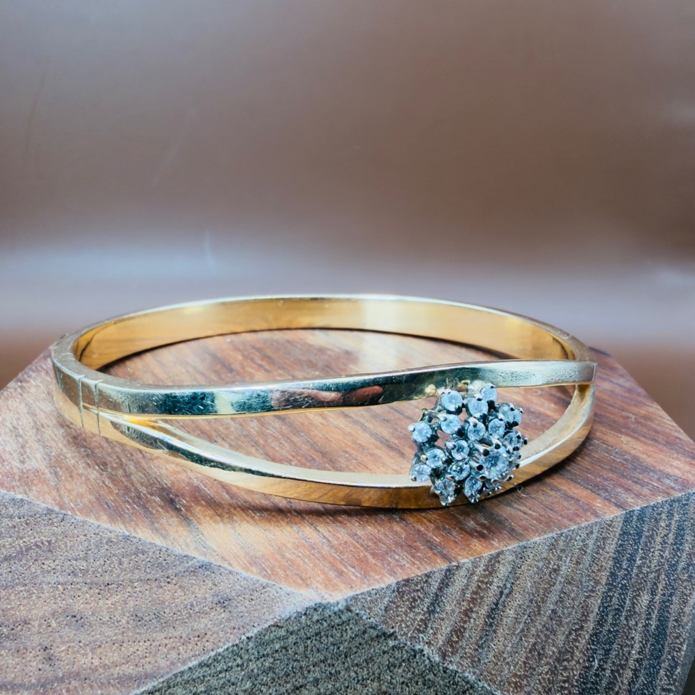 A solid 9ct yellow gold split-band cuff bangle featuring a central multi-stone diamond cluster set in a tiered round formation. View III