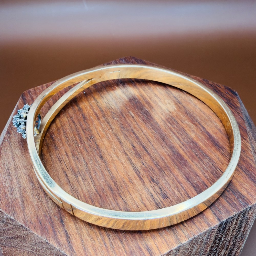 A solid 9ct yellow gold split-band cuff bangle featuring a central multi-stone diamond cluster set in a tiered round formation. View IV