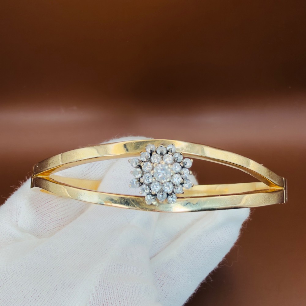 A solid 9ct yellow gold split-band cuff bangle featuring a central multi-stone diamond cluster set in a tiered round formation. View V