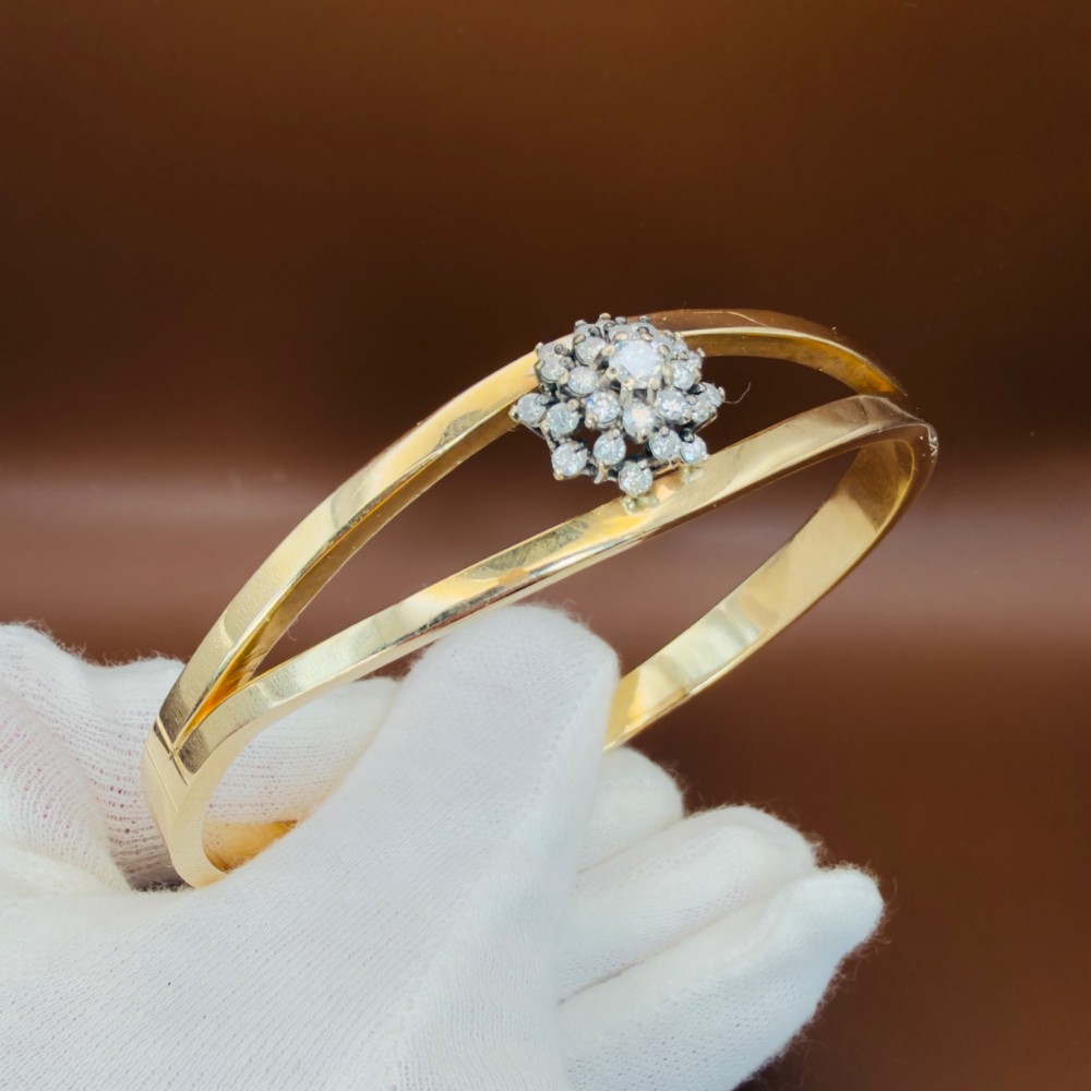 A solid 9ct yellow gold split-band cuff bangle featuring a central multi-stone diamond cluster set in a tiered round formation. View VIII