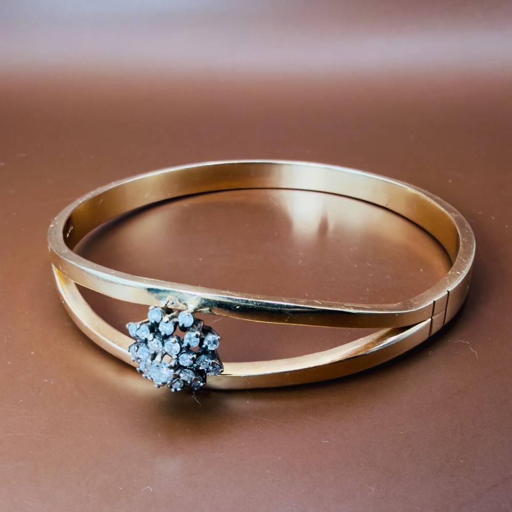 A solid 9ct yellow gold split-band cuff bangle featuring a central multi-stone diamond cluster set in a tiered round formation. View X