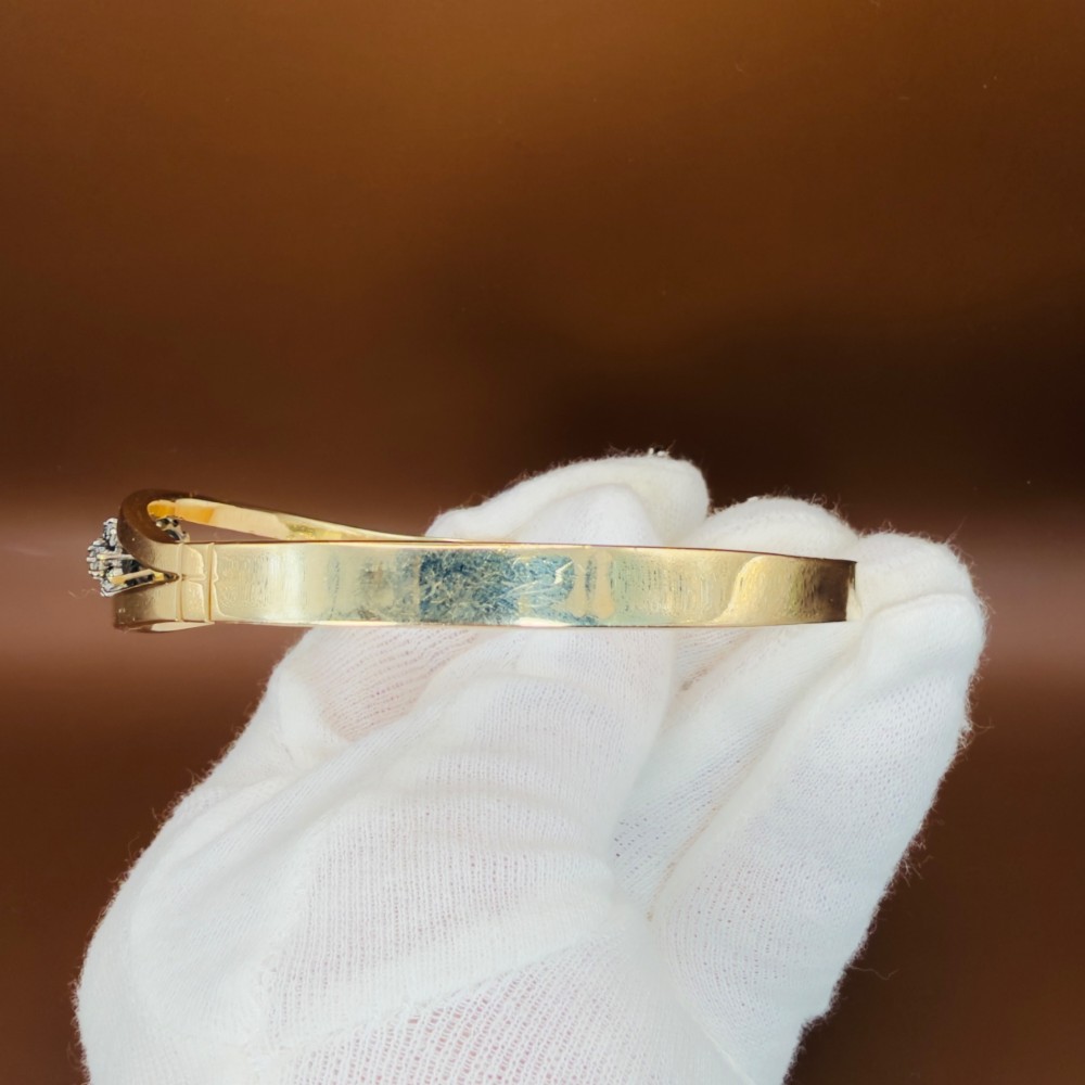 A solid 9ct yellow gold split-band cuff bangle featuring a central multi-stone diamond cluster set in a tiered round formation. View XI