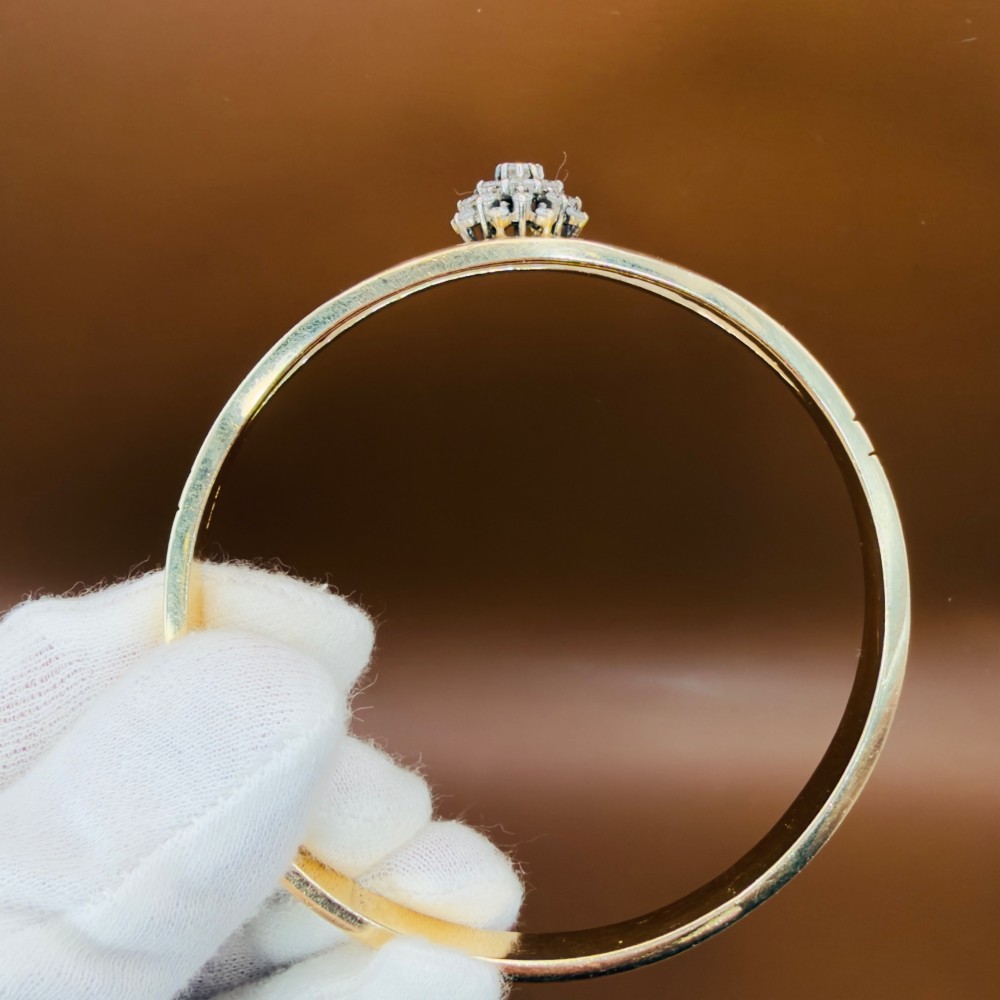 A solid 9ct yellow gold split-band cuff bangle featuring a central multi-stone diamond cluster set in a tiered round formation. View XII