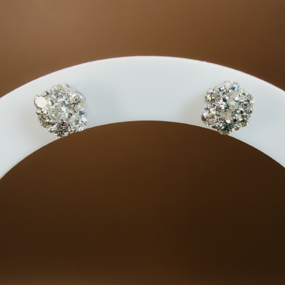 A pair of 18ct white gold cluster stud earrings featuring brilliant-cut diamonds arranged in a floral design. View II