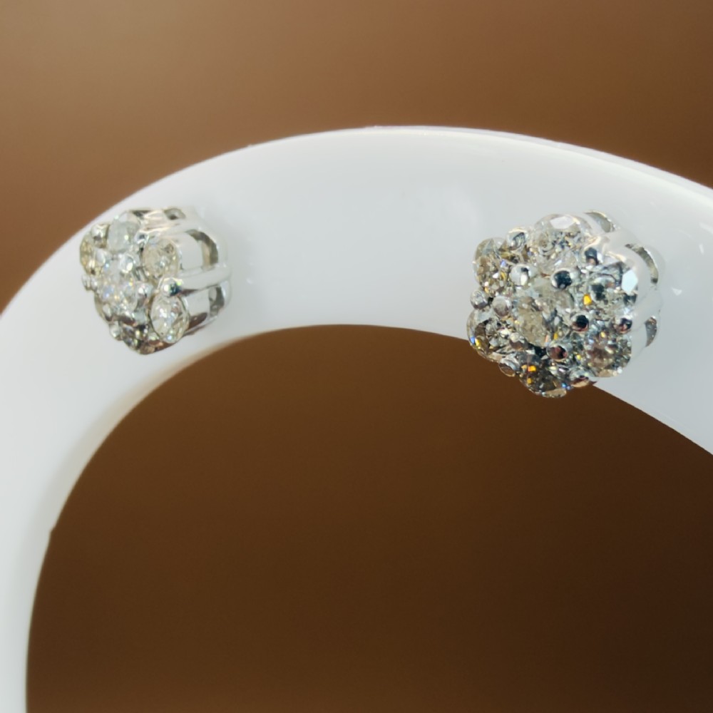 A pair of 18ct white gold cluster stud earrings featuring brilliant-cut diamonds arranged in a floral design. View III