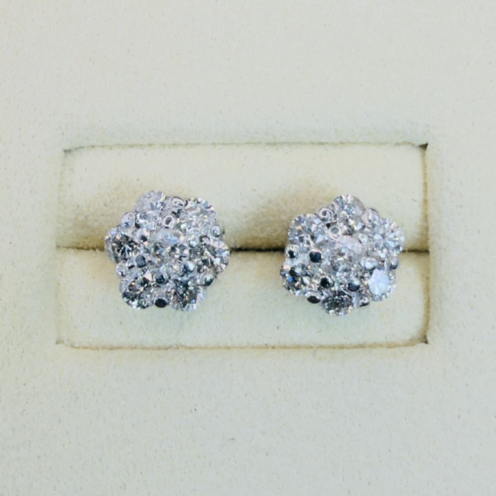 A pair of 18ct white gold cluster stud earrings featuring brilliant-cut diamonds arranged in a floral design. View V