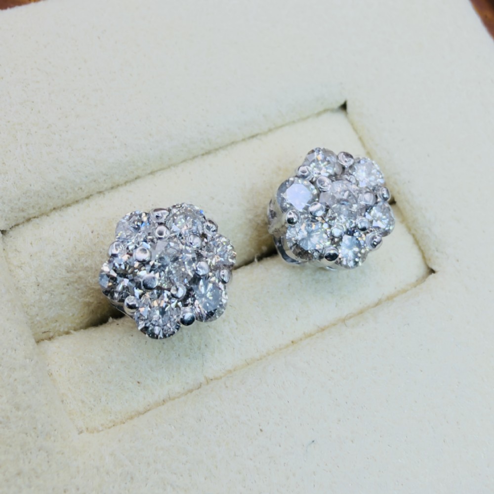A pair of 18ct white gold cluster stud earrings featuring brilliant-cut diamonds arranged in a floral design. View VII