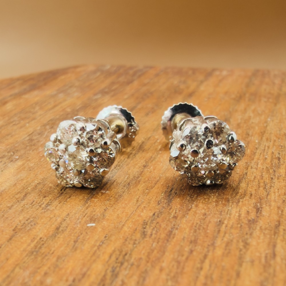 A pair of 18ct white gold cluster stud earrings featuring brilliant-cut diamonds arranged in a floral design. View VIII