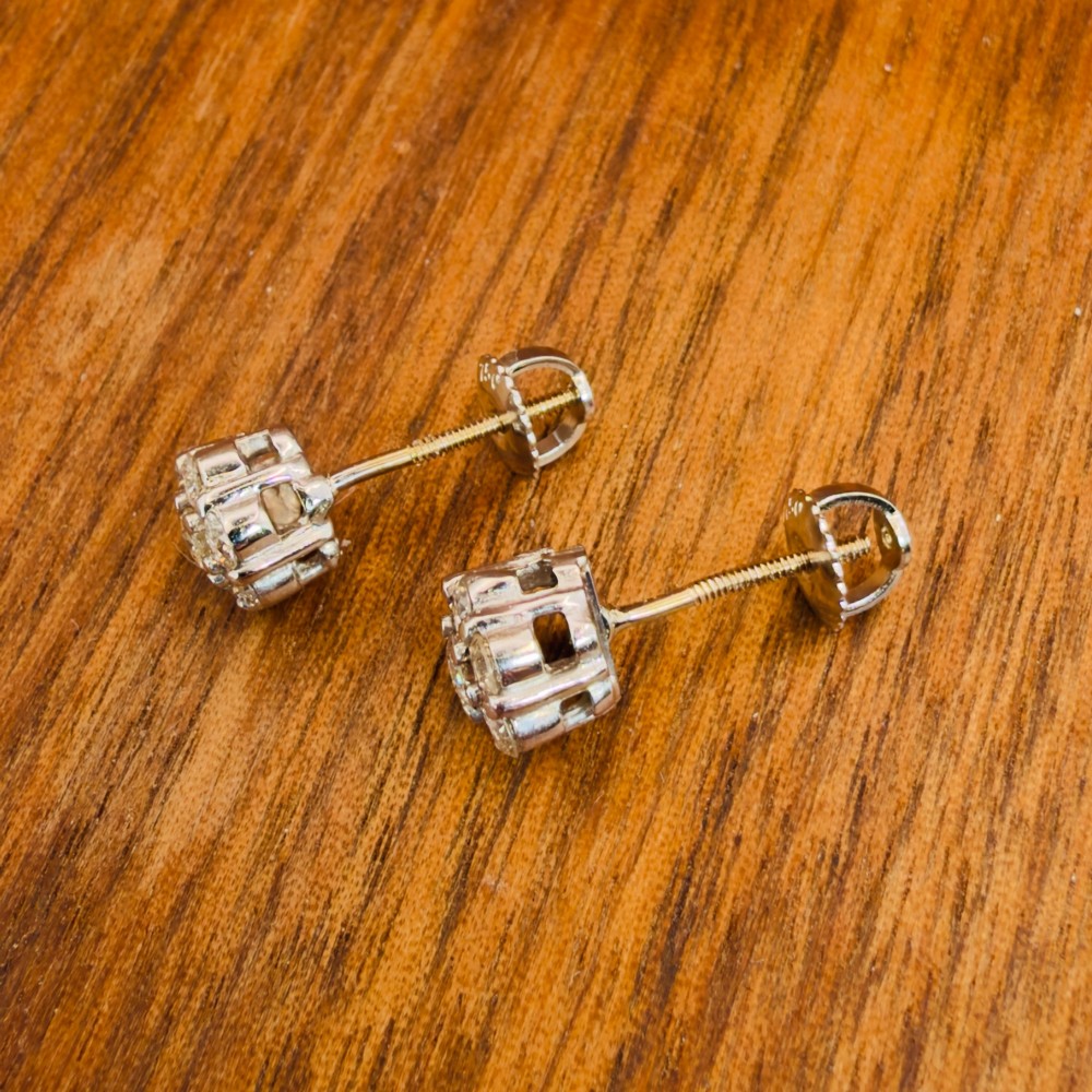 A pair of 18ct white gold cluster stud earrings featuring brilliant-cut diamonds arranged in a floral design. View X