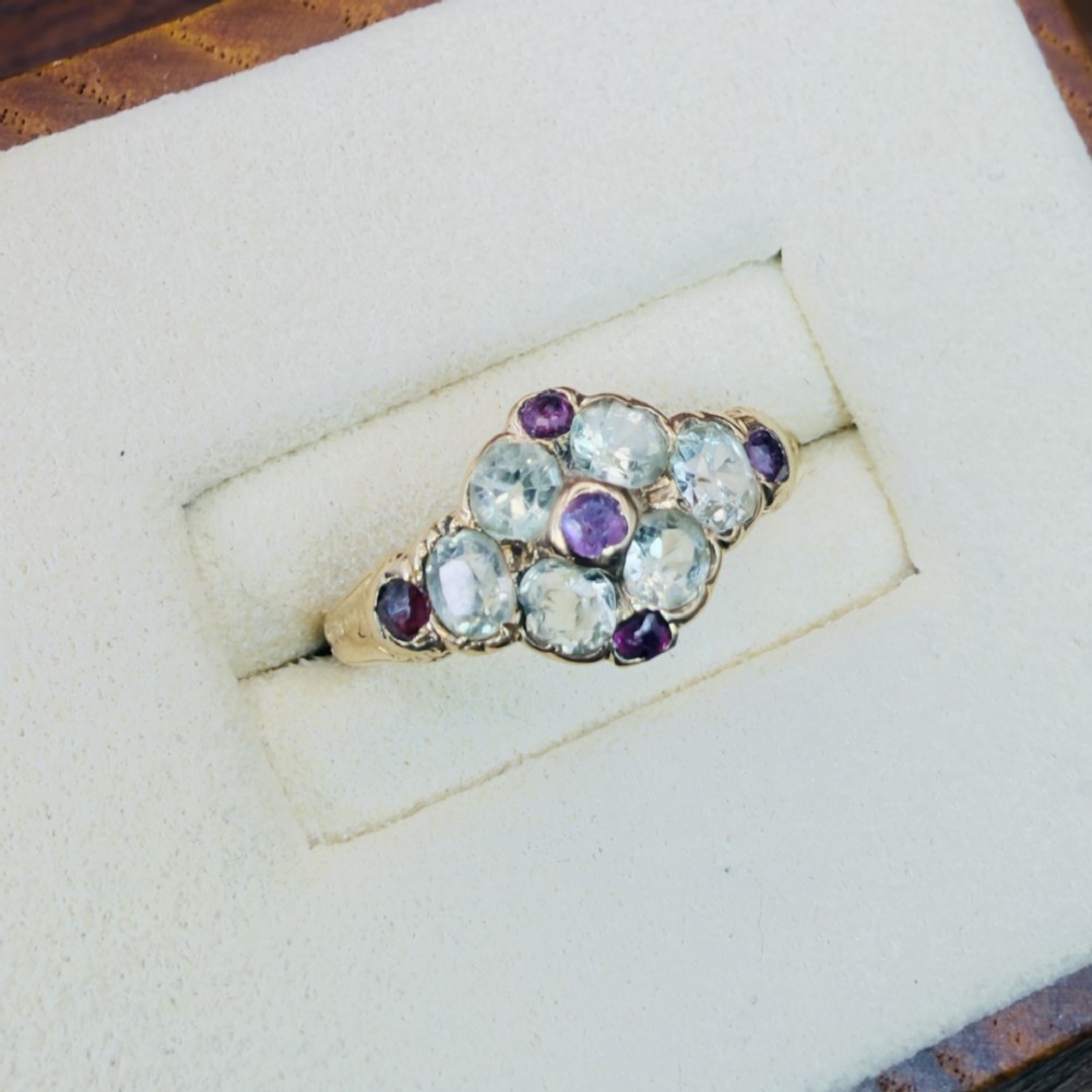 An 18ct yellow gold early Victorian cluster ring set with pale green spinels, rubies, and purple almandine garnets. View IV