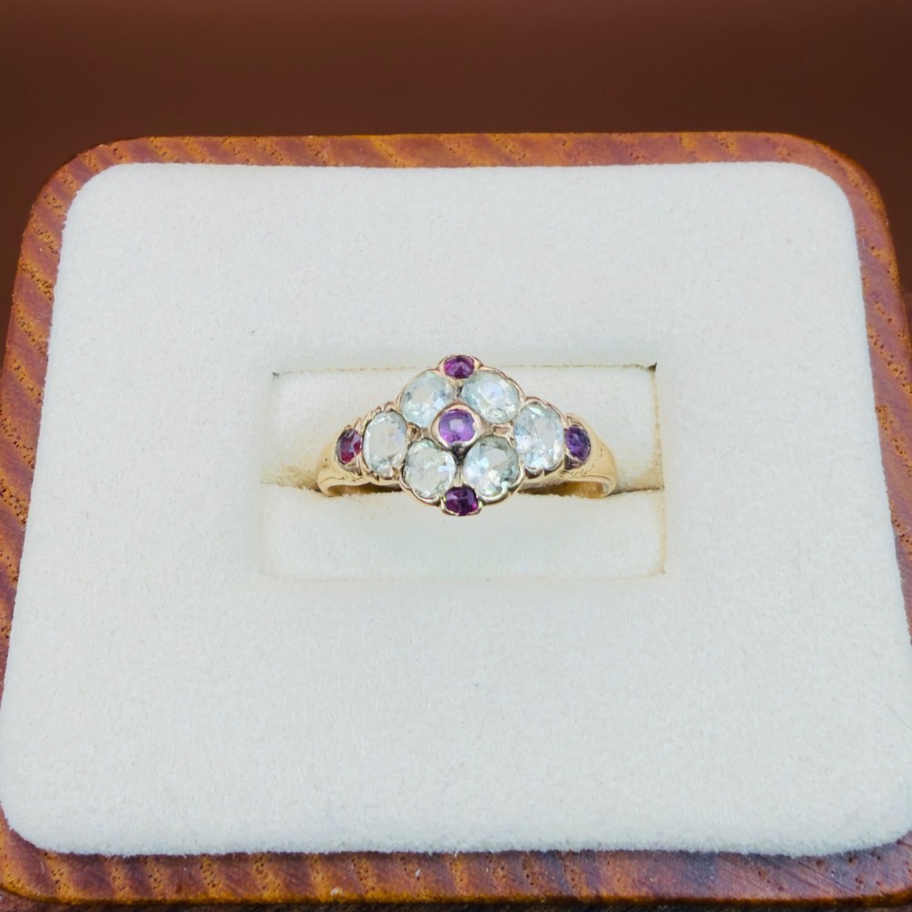 An 18ct yellow gold early Victorian cluster ring set with pale green spinels, rubies, and purple almandine garnets. View V