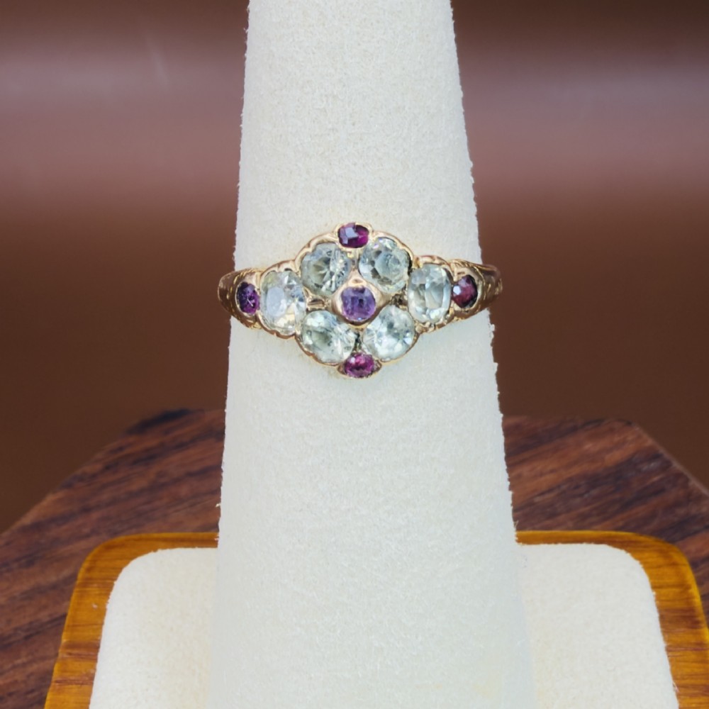 An 18ct yellow gold early Victorian cluster ring set with pale green spinels, rubies, and purple almandine garnets. View VI