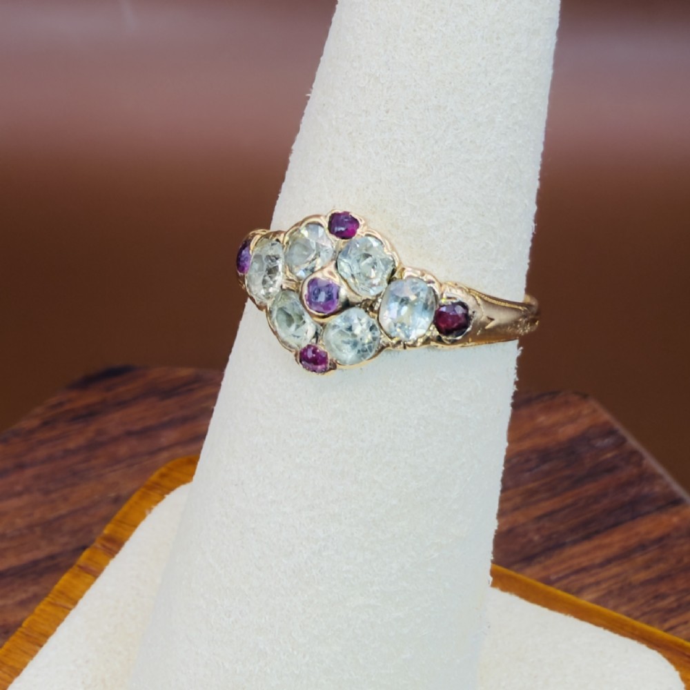 An 18ct yellow gold early Victorian cluster ring set with pale green spinels, rubies, and purple almandine garnets. View VII