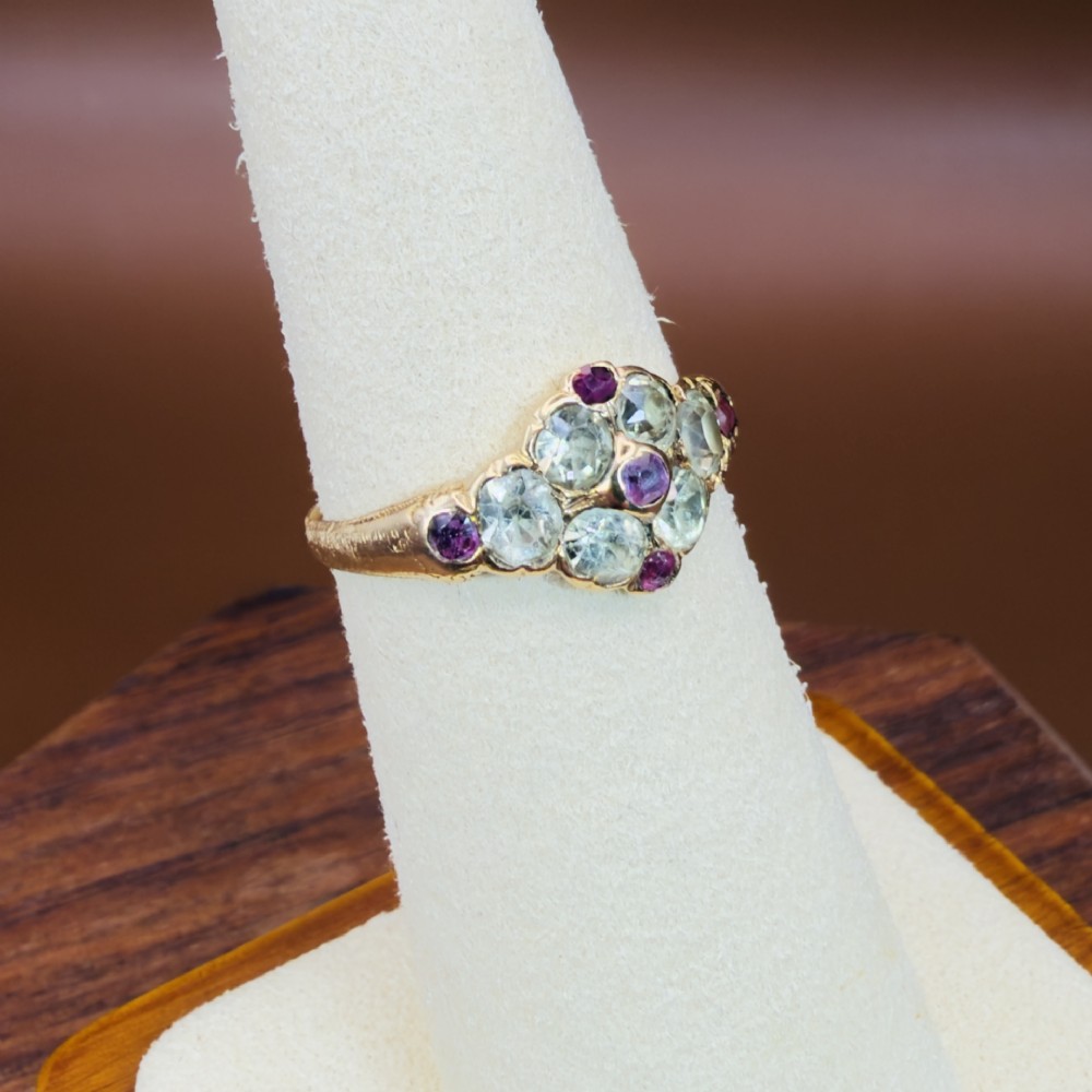 An 18ct yellow gold early Victorian cluster ring set with pale green spinels, rubies, and purple almandine garnets. View VIII