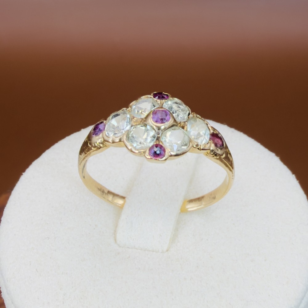 An 18ct yellow gold early Victorian cluster ring set with pale green spinels, rubies, and purple almandine garnets. View IX