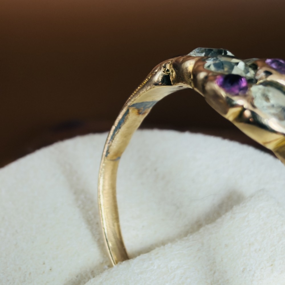 An 18ct yellow gold early Victorian cluster ring set with pale green spinels, rubies, and purple almandine garnets. View X