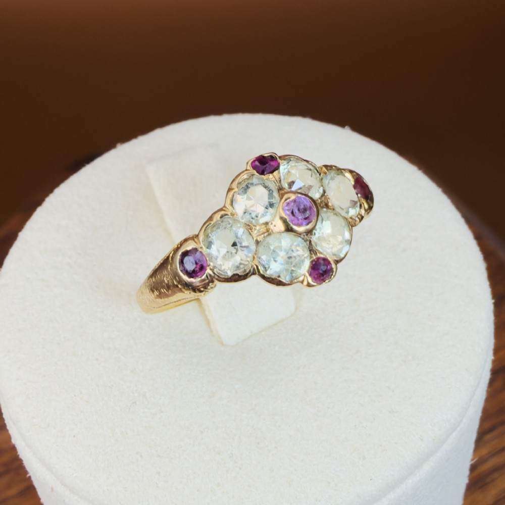 An 18ct yellow gold early Victorian cluster ring set with pale green spinels, rubies, and purple almandine garnets. View XII