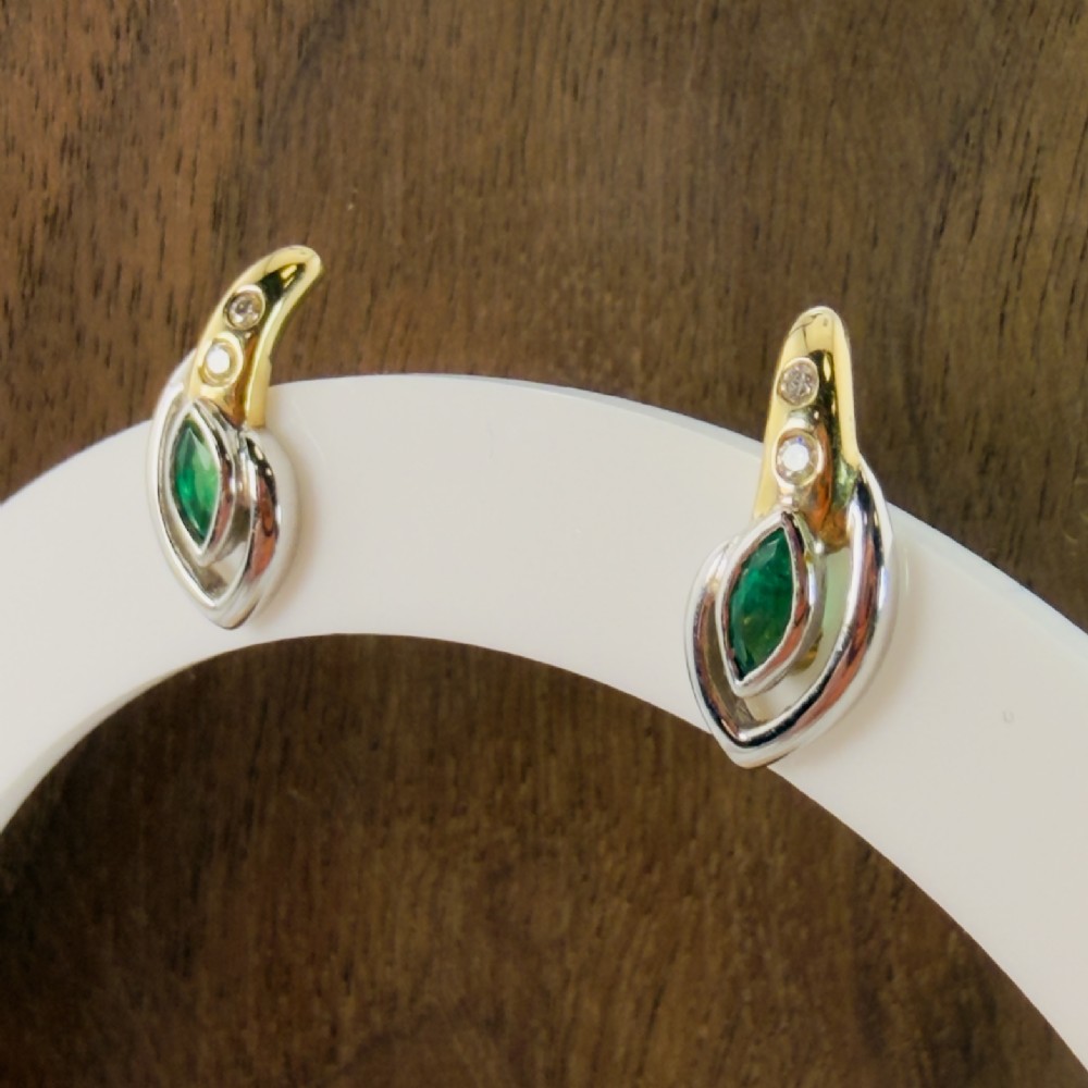 A pair of two-tone 14ct gold stud earrings set with marquise-cut green emeralds and small round diamonds. View III
