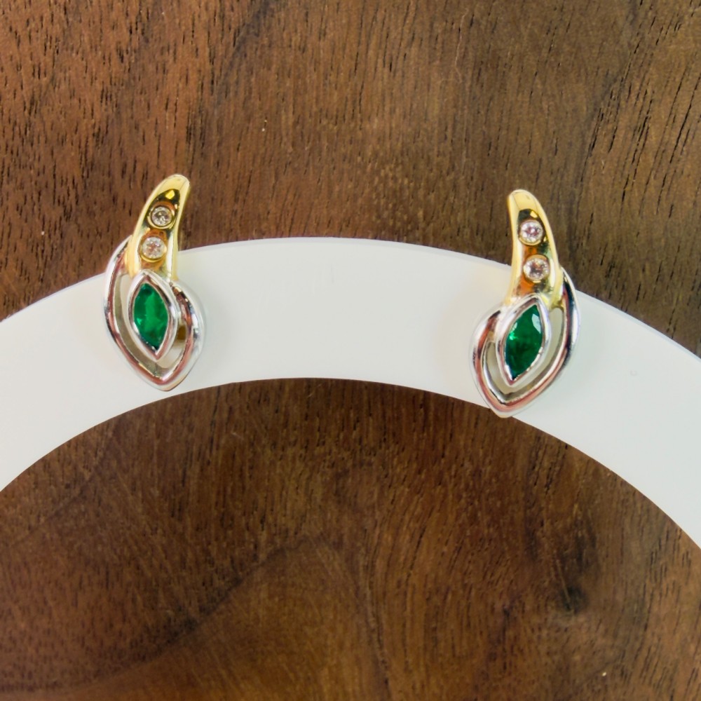 A pair of two-tone 14ct gold stud earrings set with marquise-cut green emeralds and small round diamonds. View V