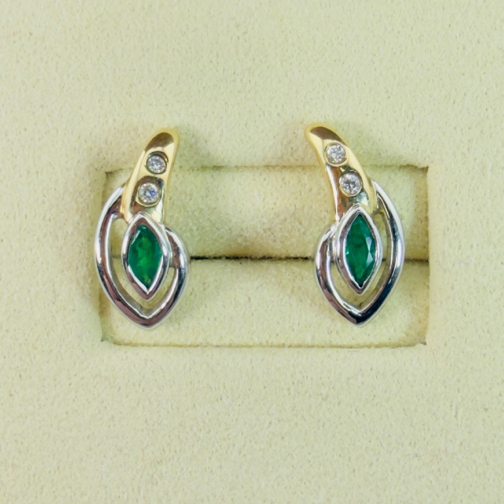A pair of two-tone 14ct gold stud earrings set with marquise-cut green emeralds and small round diamonds.