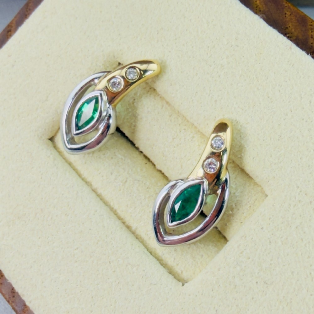 A pair of two-tone 14ct gold stud earrings set with marquise-cut green emeralds and small round diamonds. View VIII