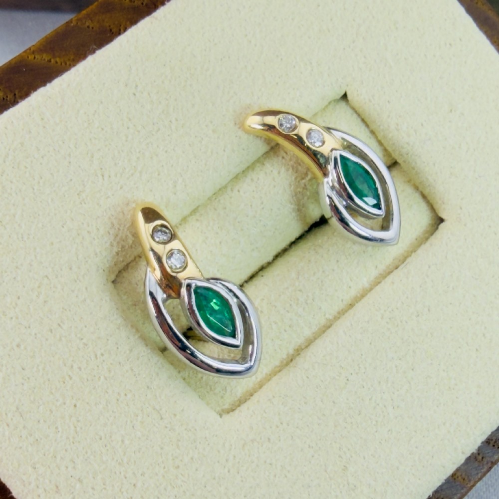 A pair of two-tone 14ct gold stud earrings set with marquise-cut green emeralds and small round diamonds. View IX