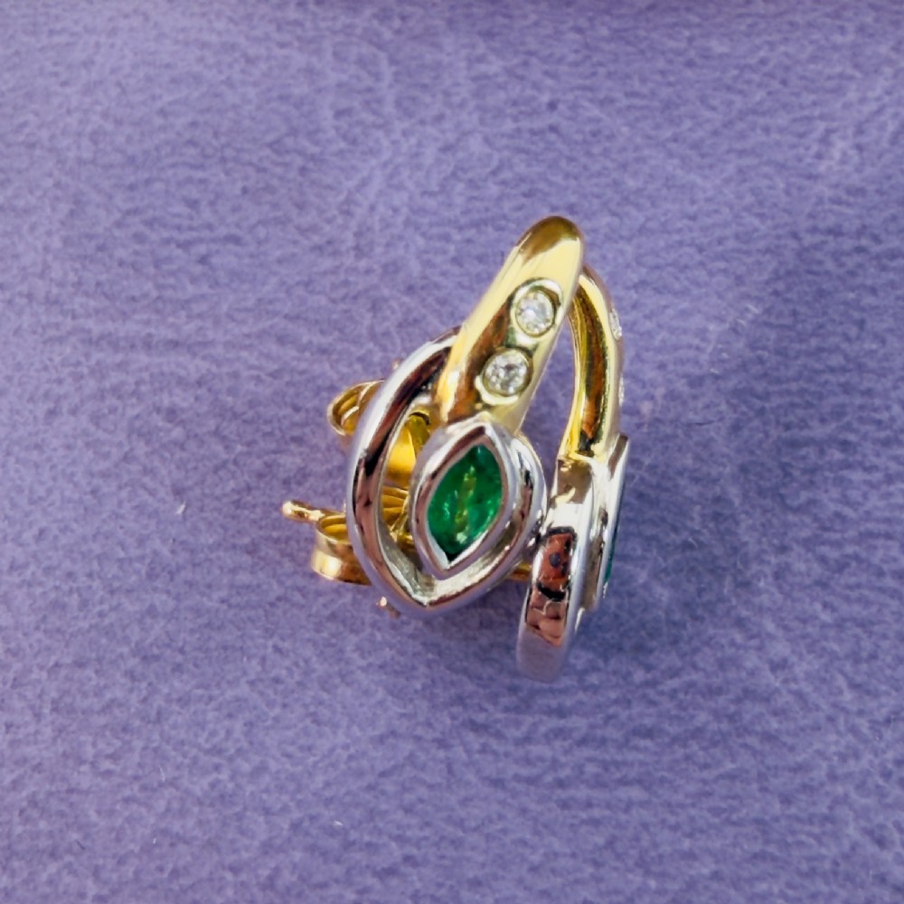 A pair of two-tone 14ct gold stud earrings set with marquise-cut green emeralds and small round diamonds. View XI