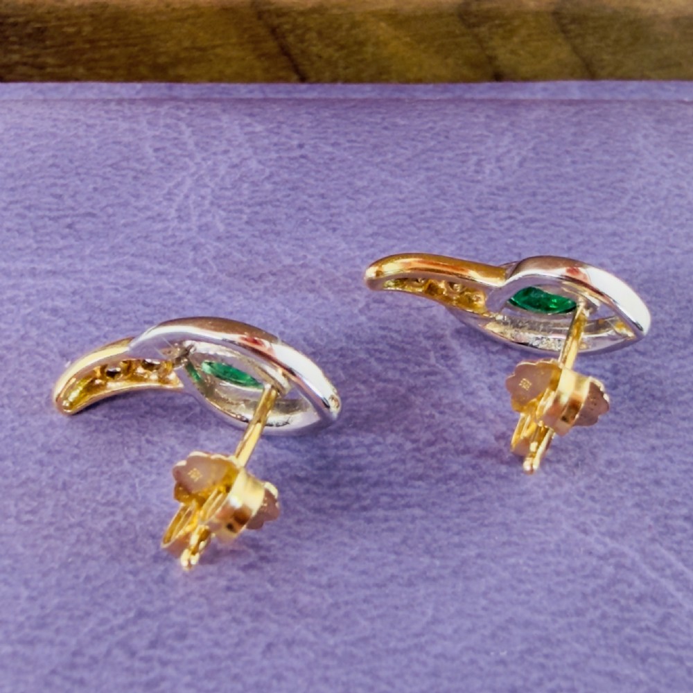 A pair of two-tone 14ct gold stud earrings set with marquise-cut green emeralds and small round diamonds. View XII