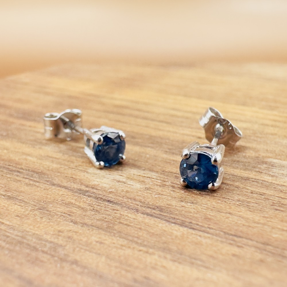 A pair of round-cut blue sapphire stud earrings set in four-claw 18ct white gold mounts. View VIII