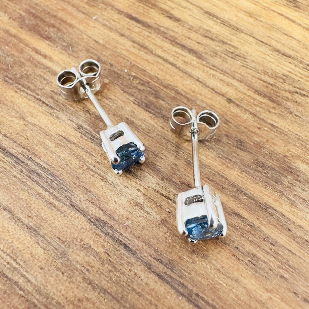 A pair of round-cut blue sapphire stud earrings set in four-claw 18ct white gold mounts. View IX