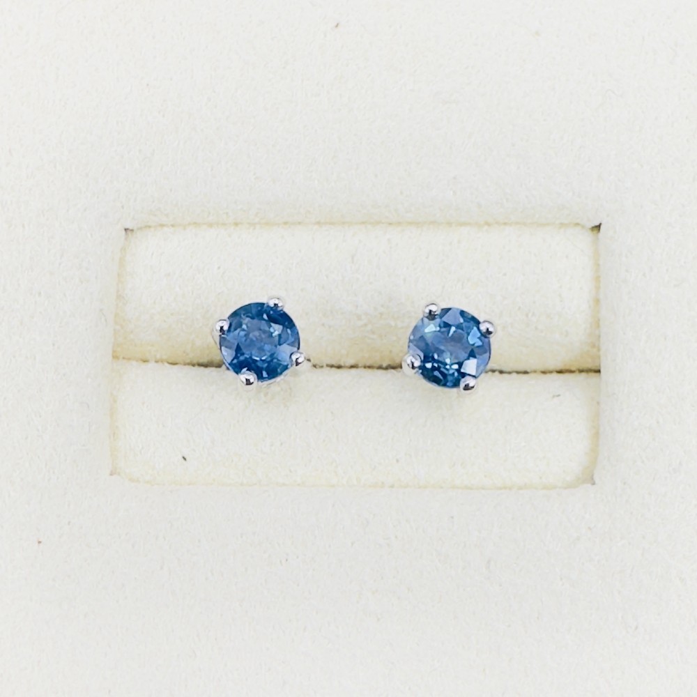 A pair of round-cut blue sapphire stud earrings set in four-claw 18ct white gold mounts. View X