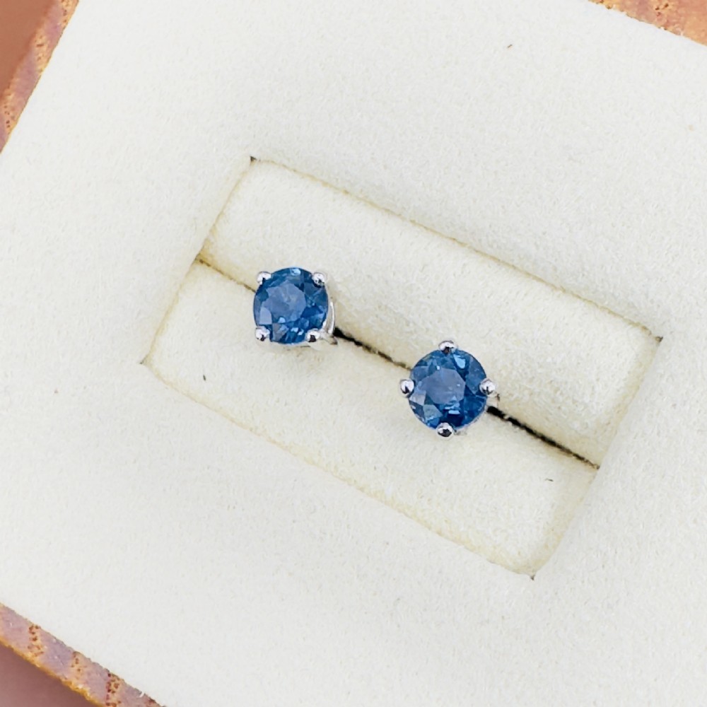 A pair of round-cut blue sapphire stud earrings set in four-claw 18ct white gold mounts.